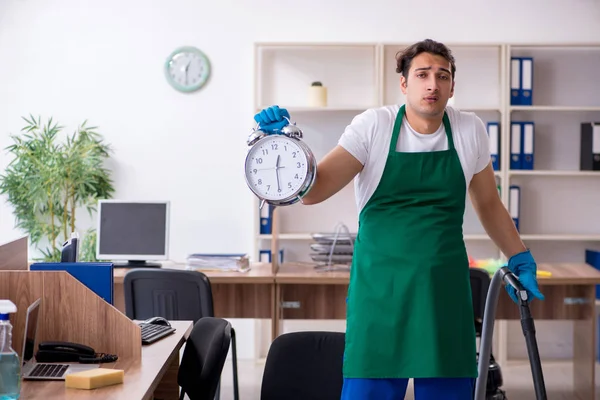 Young handsome contractor cleaning the office — Stock Photo, Image