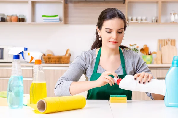 Jovem empreiteira fazendo tarefas domésticas — Fotografia de Stock