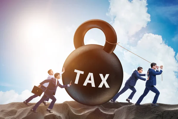 Businessman pulling kettlebell in tax concept — Stock Photo, Image