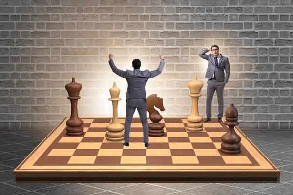 Businessman in large chess board in strategy concept — Stock Photo, Image