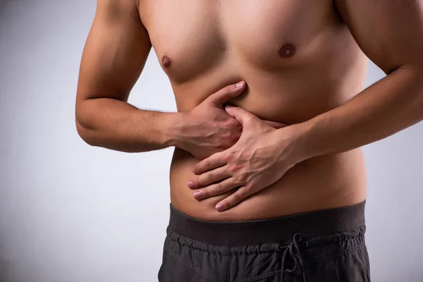 Young man suffering from stomachache — Stock Photo, Image