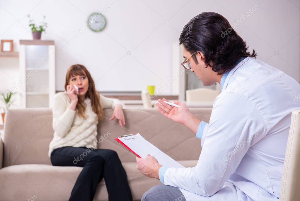 Young female patient discussing with male psychologist personal