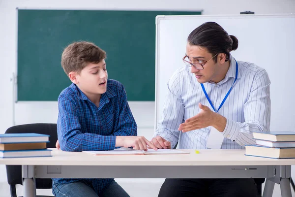 Young male teacher and boy in the classroom — Stock Photo, Image