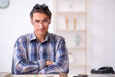 Genç erkek kuyumcu atölyede.