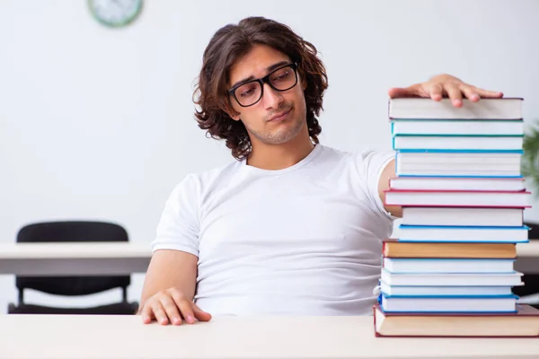 Young male student sitting in the classroom — Stock Photo, Image