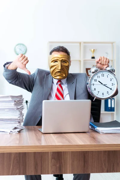 Businessman wearing mask in hypocrisy concept — Stock Photo, Image