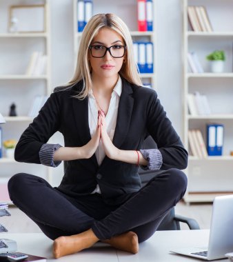 İş kadını ofiste meditasyon yaparken hayal kırıklığına uğradı