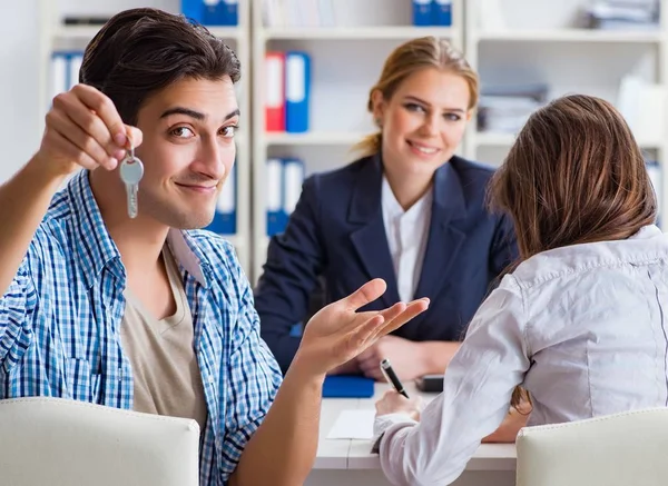 Young family agreeing mortgage contract in the bank for new hous