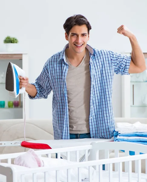 Young dad looking after newborn baby