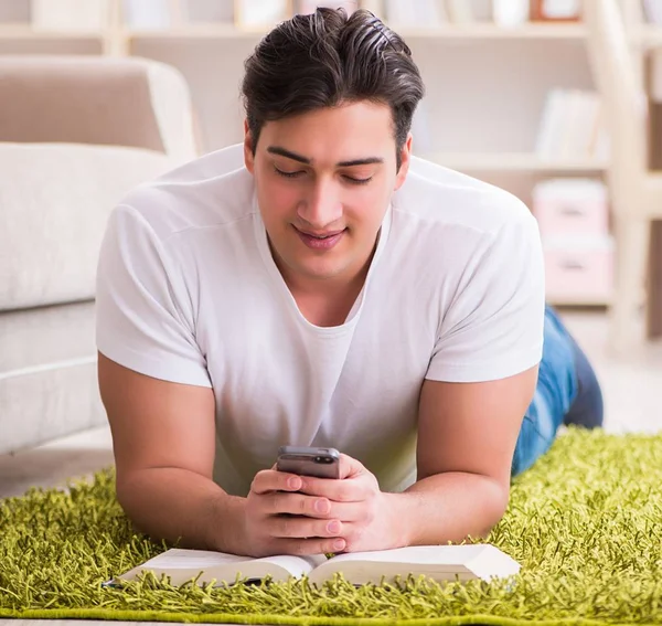 Man reading book at home on floor