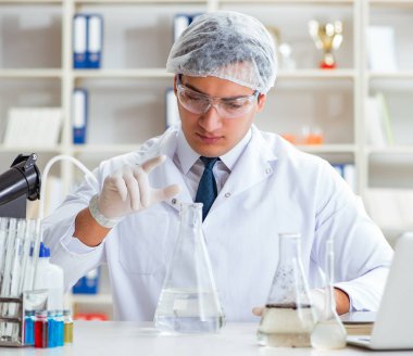 Genç araştırmacı bilim adamı bir su testi kirliliği araştırması yapıyor.