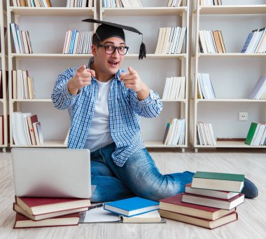 Genç öğrenci kitaplarla çalışıyor.