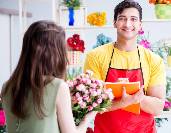 Florist selling flowers in a flower shop