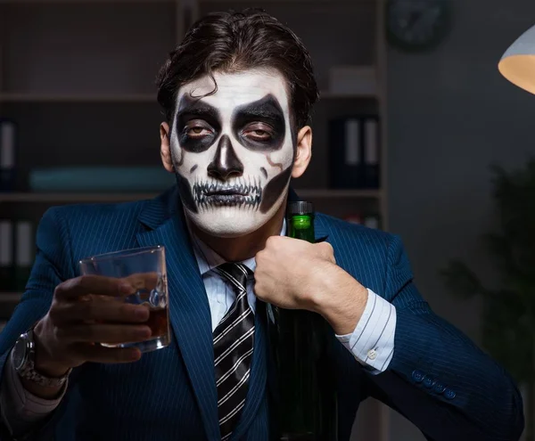 The businessman with scary face mask working late in office — Stock Photo, Image