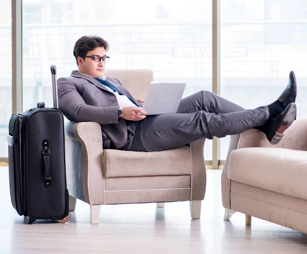 Young businessman in airport business lounge waiting for flight