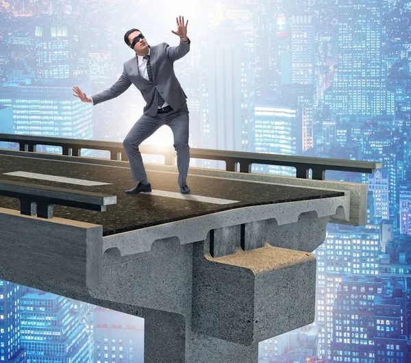 Businessman in uncertainty concept with broken bridge — Stock Photo, Image