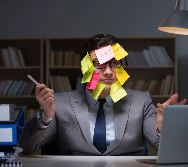 Businessman staying late to sort out priorities