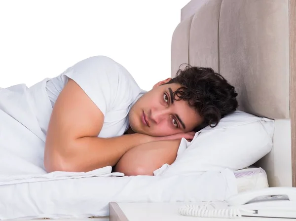 Man in bed suffering from insomnia