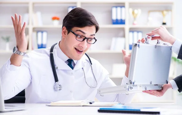 Young doctor in medical insurance fraud concept — Stock Photo, Image