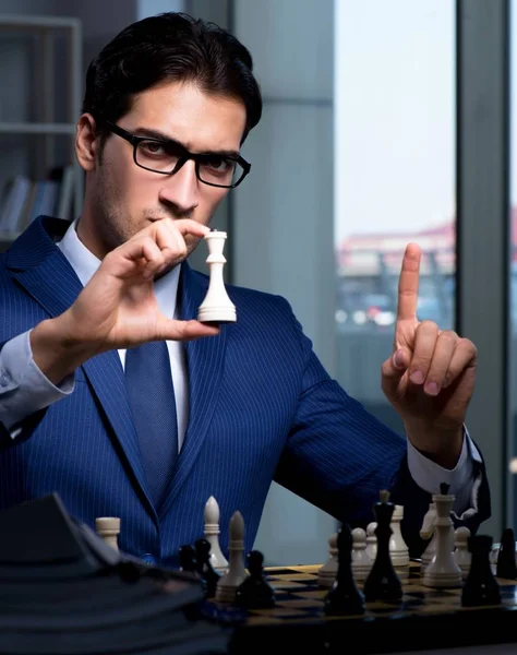 Businessman playing chess in strategy concept — Stock Photo, Image