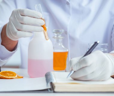 Laboratuvarda parfüm karıştıran bir kimyager.