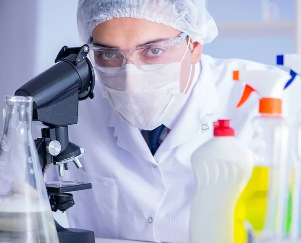 Man in the lab testing new cleaning solution detergent