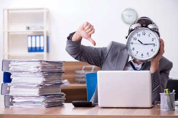 Young male employee unhappy with excessive work — Stock Photo, Image