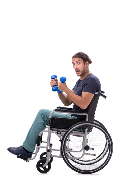 Ung handikappad man gör fysiska övningar isolerade på vitt — Stockfoto