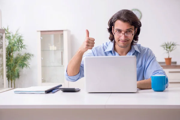 Young male employee working at home — Stock Photo, Image