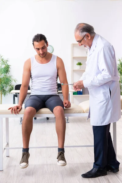 Young male patient visiting experienced doctor — Stock Photo, Image