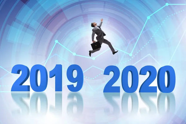Businessman jumping from year 2019 to 2020 — ストック写真