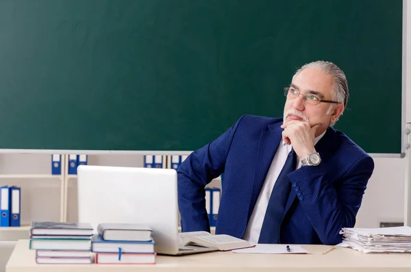 Älterer männlicher Lehrer vor Kreidetafel — Stockfoto