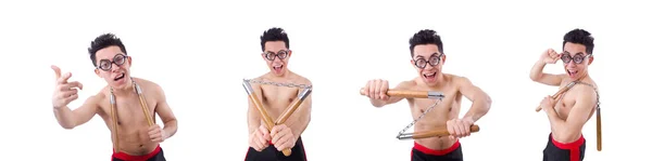 Divertente ragazzo con nunchaku su bianco — Foto Stock