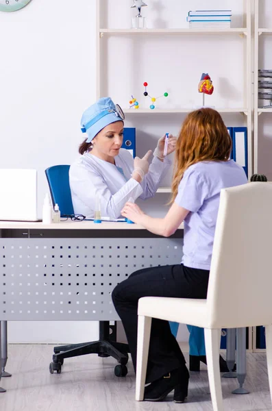 Giovane donna in visita medico femminile otorinolaringoiatra — Foto Stock