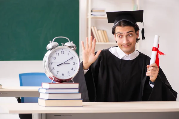 Graduate student in front of green board — Stock Photo, Image