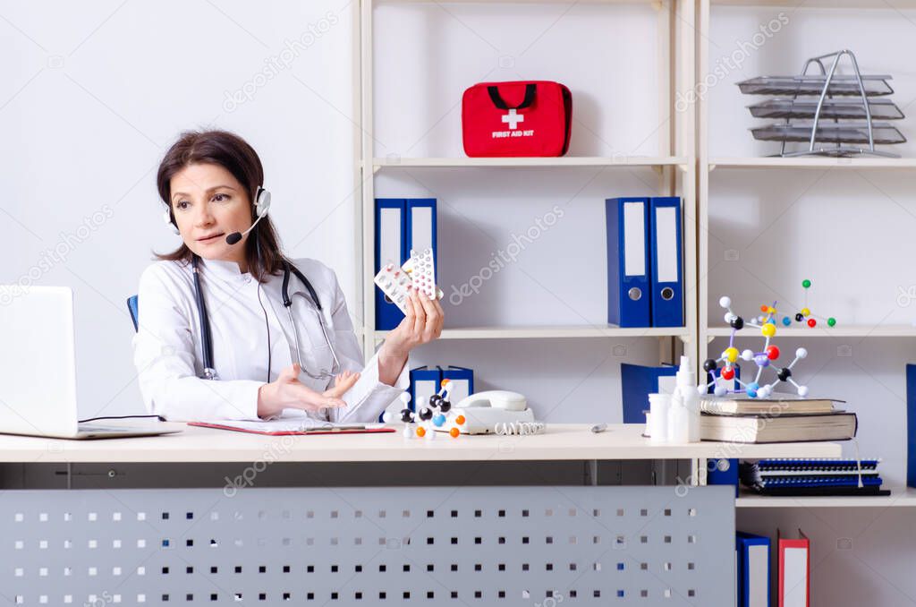 Middle-aged female doctor in telemedicine concept
