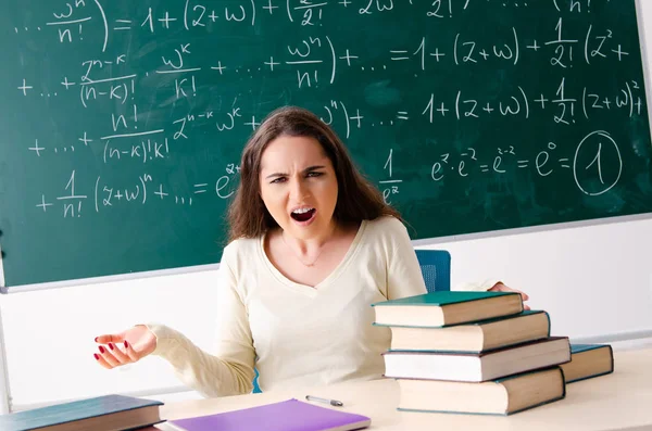 Young female math teacher in front of chalkboard — Stock Photo, Image