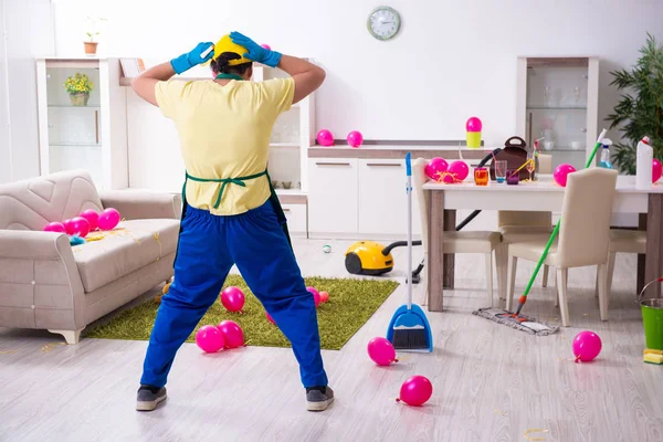 Young male contractor doing housework after party — Stock Photo, Image