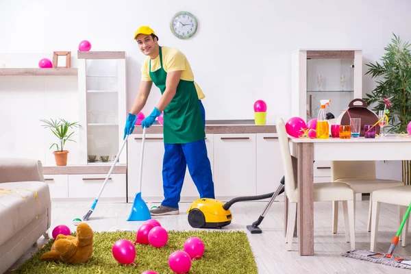 Young male contractor doing housework after party — Stock Photo, Image