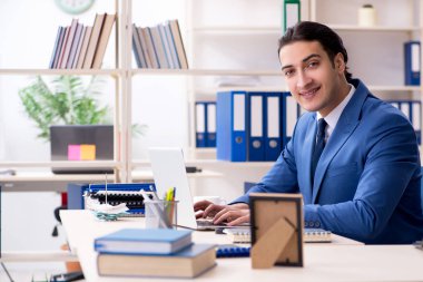 Ofisteki genç yakışıklı eleman.