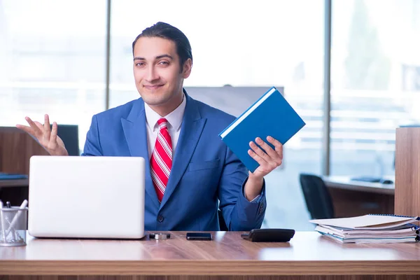 Young handsome businessman sitting in the office — Stock Photo, Image