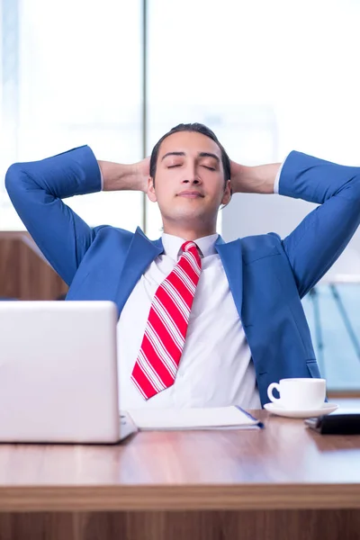 Young handsome businessman sitting in the office — Stock Photo, Image