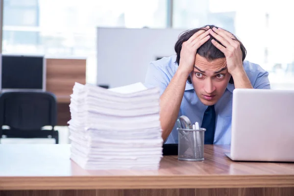 Joven empleado infeliz con el trabajo excesivo — Foto de Stock