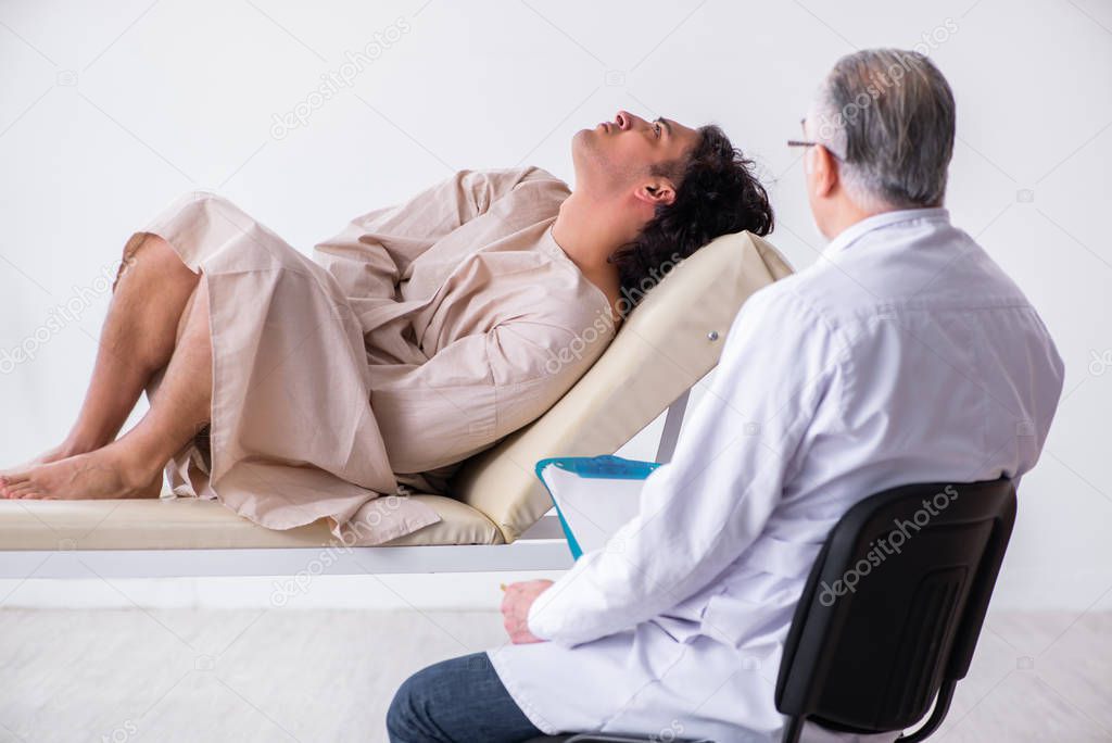 Aged male doctor psychiatrist examining young patient