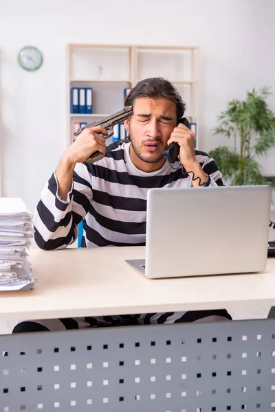 Young employee feeling like prisoner at work — Stock Photo, Image