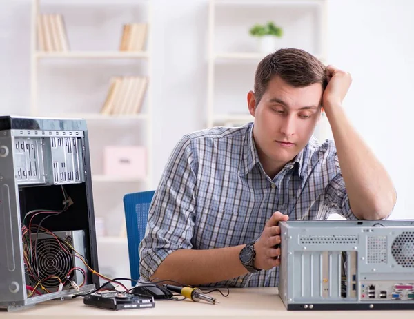 Young technician repairing computer in workshop — Stock Photo, Image