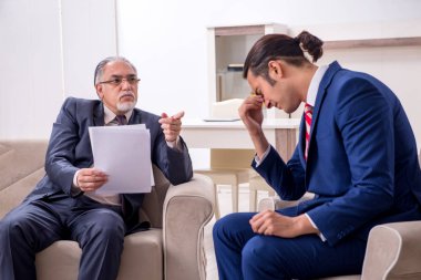 İki işadamı ofiste iş konuşuyor.