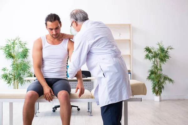 Young male patient visiting experienced doctor — Stock Photo, Image