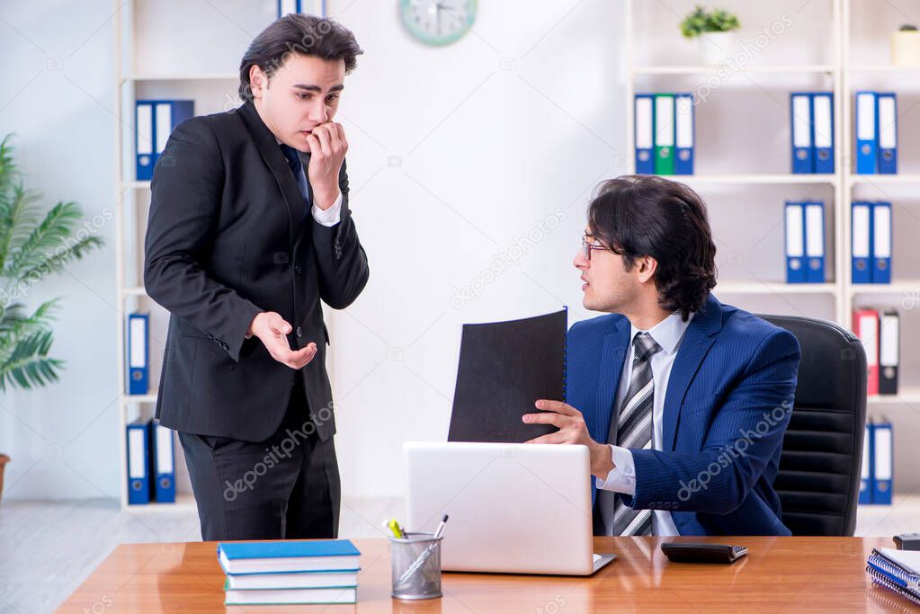 Boss and his male assistant working in the office