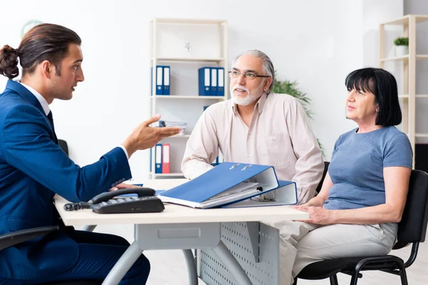 Financial advisor giving retirement advice to old couple — ストック写真